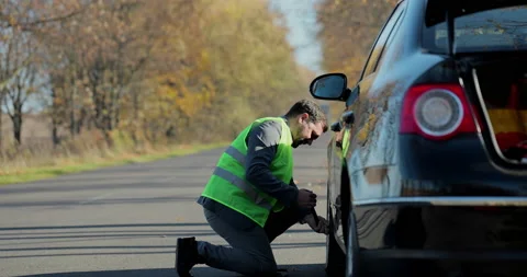 Man changing wheel on the car at the side of the road. Transportation, traveling Stock Footage 165126516