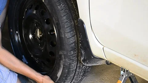 Man changing wheel Stock Footage 34694987