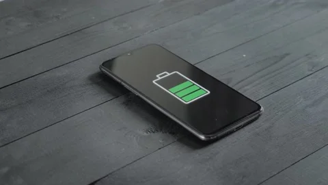 Man charge smartphone using wireless charging table. Stock Footage 201684878