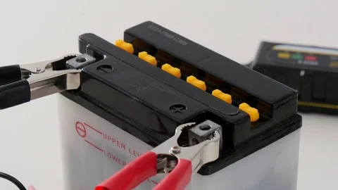 Man charging motorcycle battery Stock Footage 72400775