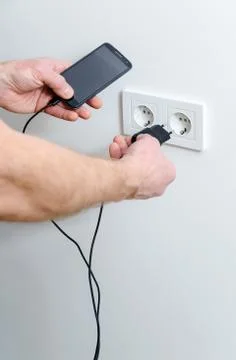 A man is charging the smartphon. Stock Photos
