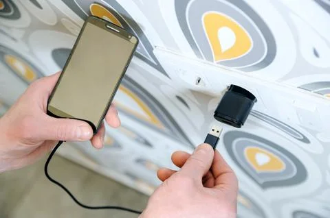 A man is charging the smartphon. Stock Photos