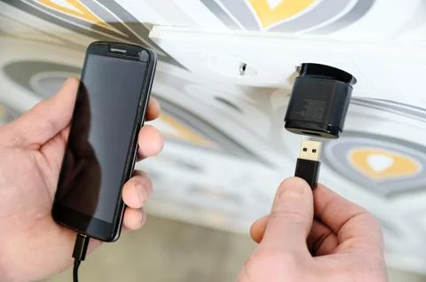 A man is charging the smartphon. Stock Photos