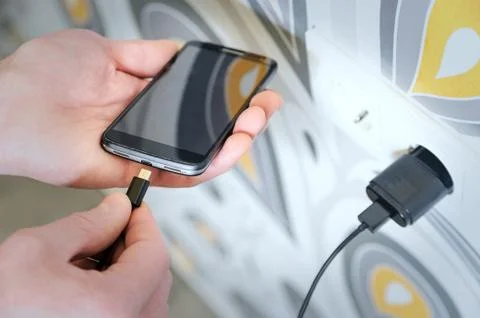 A man is charging the smartphon. Stock Photos