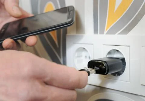 A man is charging the smartphon. Stock Photos
