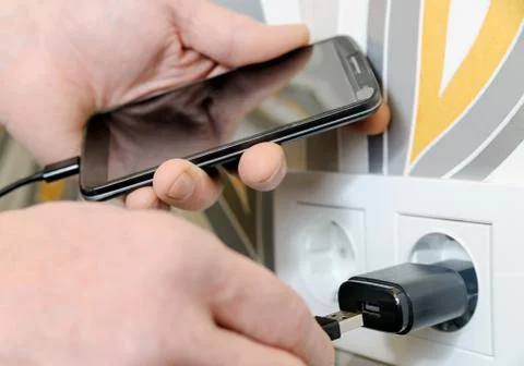 A man is charging the smartphon. Stock Photos