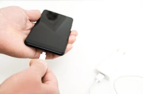 A man is charging the smartphon. Stock Photos