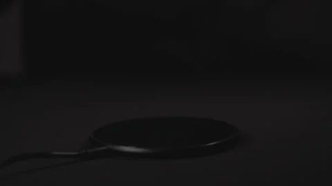 Man Charging Smartphone Using Wireless Charging Pad At Home. Stock Footage 300343700