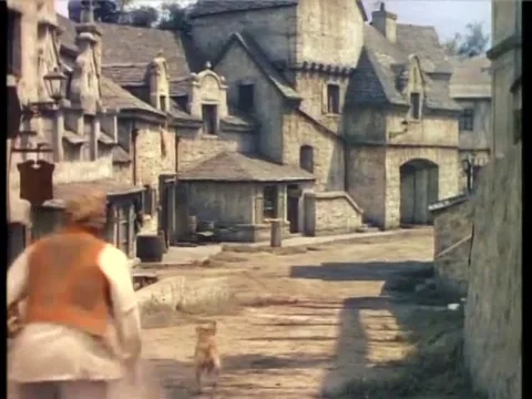 Man chasing after dog chasing ball in village, 1940s Stock Footage 61766890