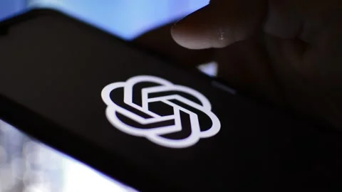 Man with chat gpt app on the iphone screen in a blur background. Stock Footage 233082234