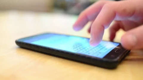 A man chating with Smartphone mobile cell phone at the table Stock Footage 83008179