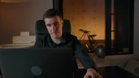 A man chats at an online conference using laptop from his apartment Stock Footage 142961981