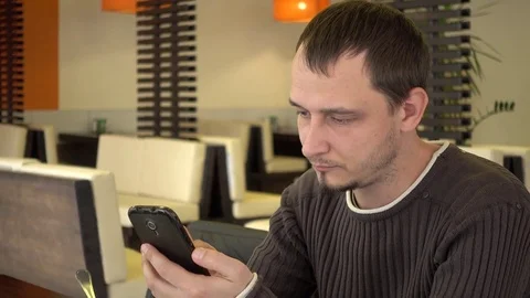 Man Chatting Google Maps By Mobile Cell Phone At The Table Fast Food Cafe Stock Footage 70996231