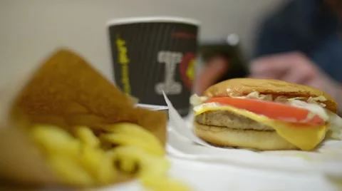 A Man chatting with iphone Mobile Cell Phone at the Table Fast Food Cafe Stock Footage 61012086