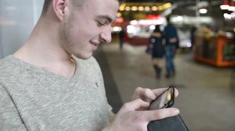 A man chatting with Smartphone mobile cell phone in a Mall Stock Footage 60377634
