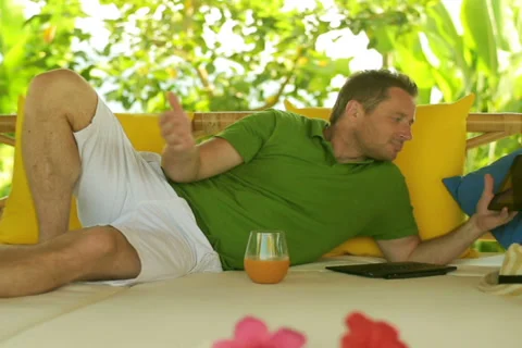 Man chatting on tablet and lying on bed Stock-Footage 39885825