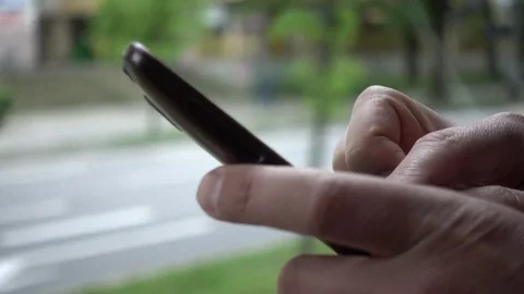 Man chatting use Mobile Phone ride through City Wroclaw inside Tram window Stock Footage 75458181