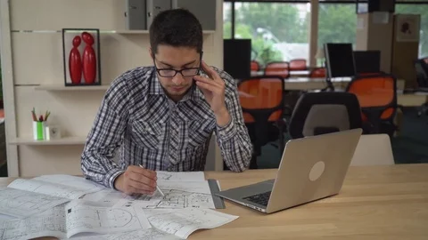 Man check architectural sketch talking with client on the mobile phone 動画素材 72325412