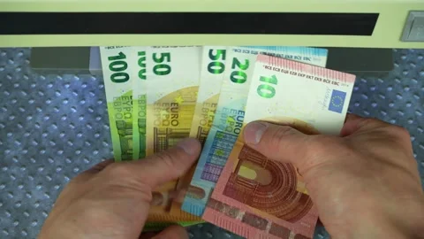 Man check bills on bill detector with UV light. Checking euro banknotes in a UV Stock-Footage 303755374