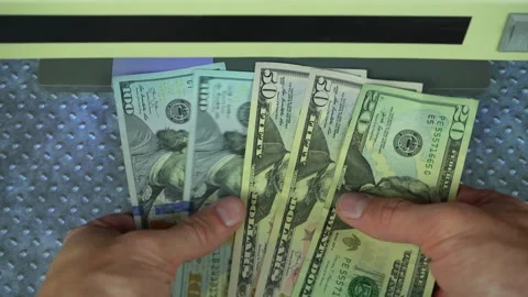 Man check dollars on bills detector with UV light Video stock 303756084