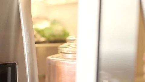 Man in checked shirt opening fridge door taking out vegetables Stock Footage 79836070
