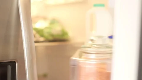 Man in checked shirt opens fridge door takes out melon Stock-Footage 79836097