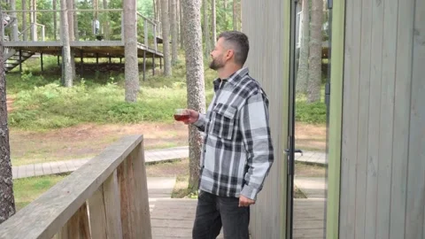 Man in checkered warm shirt drinking hot tea Video stock 282382550