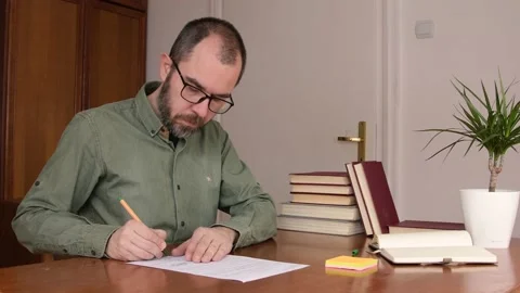 Man checking and signing paper document at home office. Stock Footage 151602463