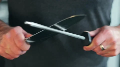 Man checking blade after sharpening knife. Chef preparing to cook food Stock Footage 160360524
