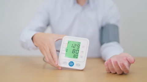 Man checking Blood pressure by Blood pressure monitor with Cuff. Systolic, .. Stock Footage 334786524