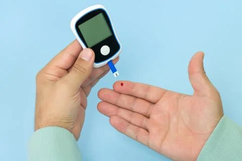 Man checking blood sugar level with glucometer. Diagnostic and treatment of d Stock Photos