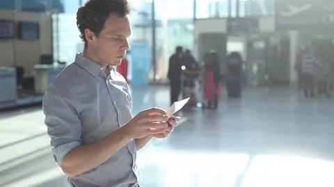 Man checking boarding pass and number of gate in the airport Stock Footage 96127247