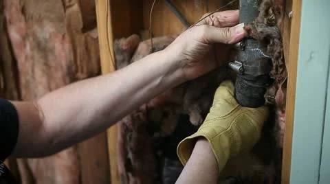 Man checking broken water pipe Stock Footage 11803264