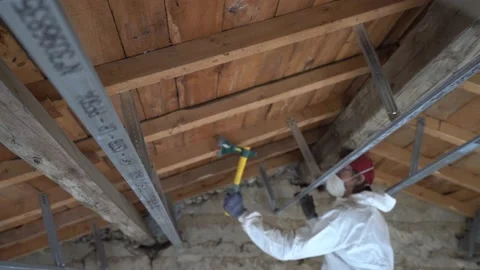 A Man Checking Building Framework With An Axe For Parasites and Damages Stock Footage 203834632