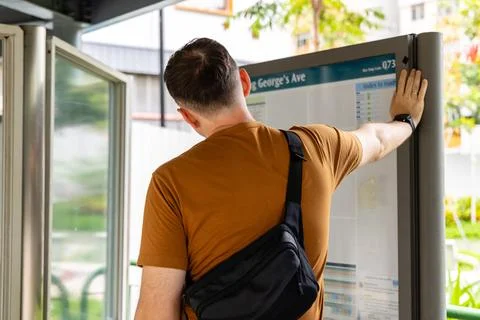 Man checking bus stop map at King George's Ave Singapore Stock Photos