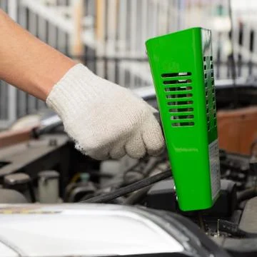 Man checking car battery. checking car battery level with a load fork Stock Photos
