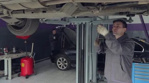 Man Checking Car Bottom Stock Footage 62166713