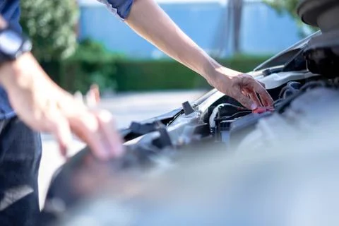 A man checking car engine, Check and maintenance the battery in car with your Stock Photos