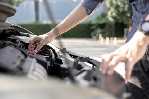 A man checking car engine, Check and maintenance the battery in car with your Stock Photos