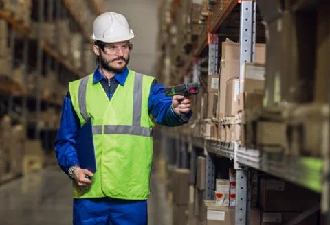 Man checking cargo on shelves with scanner Stock Photos