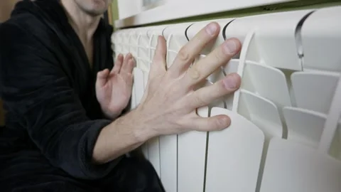 Man Checking Central Heating Radiator Temperature For Winter Warmth Stock Footage 328277365