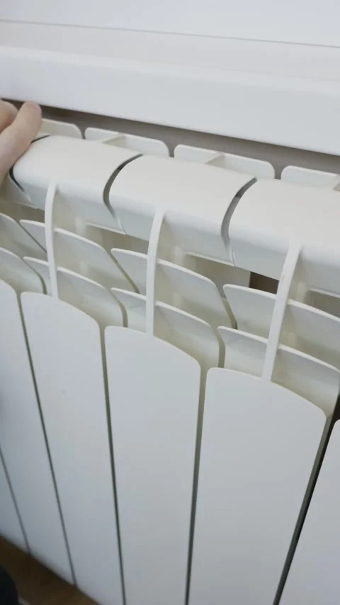 Man Checking Central Heating Radiator Temperature At Home Stock Footage 329484700