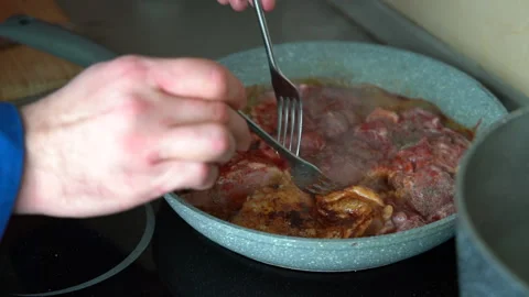Man checking chicken thighs on pan Stock Footage 161158503