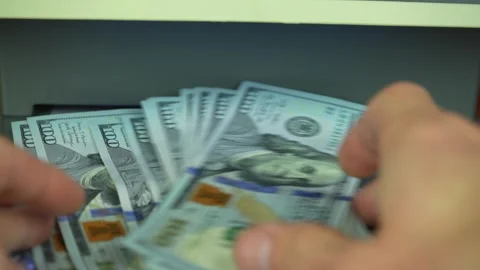 Man checking dollar banknotes with currency detector, closeup Stock Footage 304265603