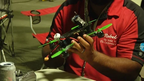 Man checking drone before race Stock Footage 99050546
