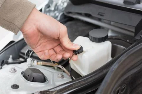 Man checking the engine of his car Stock Photos