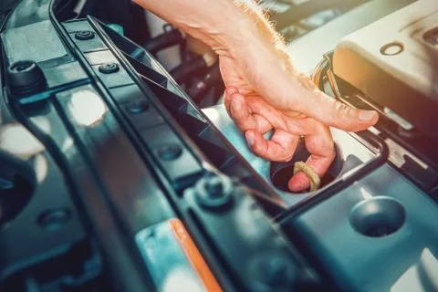 Man checking engine oil dipstick of a modern car Stock Photos