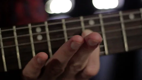 Man checking a guitar sound and twists the strings Stock Footage 113182441