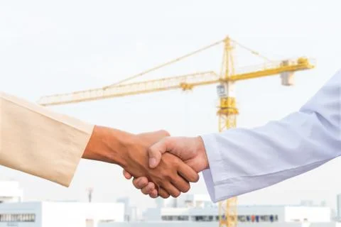 The man checking the hand with commitment to sucess at construction site and  Stock Photos