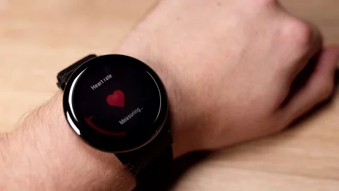 Man checking heart rate, measuring pulse with smart watch, fitness bracelet on w Stock Footage 224145230